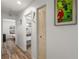 Hallway featuring wood-look tile flooring and access to the bedroom and bathroom at 12815 Tallowood Dr, Riverview, FL 33579