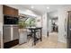 Breakfast nook featuring tile floor, modern appliances, and an open view to the living area at 12815 Tallowood Dr, Riverview, FL 33579