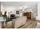 Bright living room with wood-look tile flooring, neutral walls, and a decorative hutch at 12815 Tallowood Dr, Riverview, FL 33579