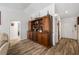 Hallway area featuring wood-look tile and a large hutch at 12815 Tallowood Dr, Riverview, FL 33579