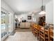 Open-concept living room with wood-look tile flooring, view to dining area, and back yard at 12815 Tallowood Dr, Riverview, FL 33579