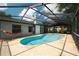 Relaxing screened-in pool area with a hammock and ample space for lounging and entertaining at 12815 Tallowood Dr, Riverview, FL 33579
