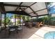 Spacious screened-in pool area with comfortable seating and an outdoor dining set at 12815 Tallowood Dr, Riverview, FL 33579
