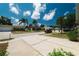 Neighborhood street view with well-maintained homes and lush palm tree landscaping at 12815 Tallowood Dr, Riverview, FL 33579