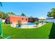 Exterior view of the pool and yard, featuring a private in-ground pool and verdant green grass at 13024 124Th Ave, Largo, FL 33774