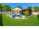 Beautifully landscaped backyard featuring a refreshing pool, patio, and an outdoor workout machine at 13024 124Th Ave, Largo, FL 33774