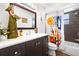 Bathroom features a large mirror, dark wood vanity, and colorful floral shower curtain at 13024 124Th Ave, Largo, FL 33774