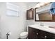 Bathroom with dark wood vanity, modern fixtures, medicine cabinet, and tiled walk-in shower at 13024 124Th Ave, Largo, FL 33774