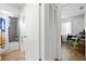 Bathroom with a tiled shower/tub combination and a peek into the cluttered home office at 13024 124Th Ave, Largo, FL 33774