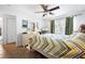 Well-lit bedroom with tile floors, ceiling fan, and easy access to the en-suite bathroom at 13024 124Th Ave, Largo, FL 33774