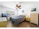 Cozy bedroom featuring tile floors, ceiling fan, and ample natural light from the window at 13024 124Th Ave, Largo, FL 33774