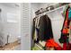 Walk-in closet with built-in shelves and ample storage space, seamlessly connected to the bathroom at 13024 124Th Ave, Largo, FL 33774