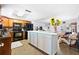 Spacious kitchen featuring tile flooring, sleek appliances, and a large center island, creating a culinary haven at 13024 124Th Ave, Largo, FL 33774