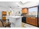 Bright kitchen featuring tile flooring, wooden cabinets, and a ceiling fan, creating a practical space at 13024 124Th Ave, Largo, FL 33774