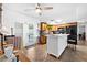 Bright kitchen featuring tile flooring, wooden cabinets, and a large island that opens to the adjacent backyard at 13024 124Th Ave, Largo, FL 33774