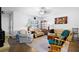 Bright living room featuring tile flooring, neutral-colored furniture, and ample natural light from the large windows at 13024 124Th Ave, Largo, FL 33774