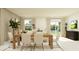 Open-concept dining and living area filled with natural light from windows and a sliding glass door at 13186 Goldstone Ct, Wimauma, FL 33598