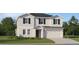 Charming two-story home with a two-car garage, well-maintained lawn, and neutral color scheme at 13186 Goldstone Ct, Wimauma, FL 33598