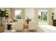 Bright living room featuring a sectional sofa, neutral tones, and view to outdoor patio at 13186 Goldstone Ct, Wimauma, FL 33598