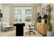 Bright office with a modern desk, stylish chair, and large windows offering natural light at 13186 Goldstone Ct, Wimauma, FL 33598
