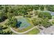 Aerial view of the community basketball court with adjacent gazebo, tennis court and walking path views at 13610 S Village Dr # 4212, Tampa, FL 33618