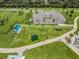Aerial view of community fitness park with playground, parking, and green space at 13610 S Village Dr # 4212, Tampa, FL 33618