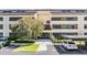 Building entrance featuring well-maintained landscaping, covered parking, and accessible entrance at 13610 S Village Dr # 4212, Tampa, FL 33618
