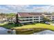 Condo complex showcasing lush landscaping, water view, and ample parking at 13610 S Village Dr # 4212, Tampa, FL 33618