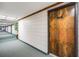 Well-lit hallway leading to unit 212, featuring carpeted floors and decorative wall accents at 13610 S Village Dr # 4212, Tampa, FL 33618