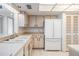Bright kitchen with white appliances, ample counter space, and neutral accents at 13610 S Village Dr # 4212, Tampa, FL 33618