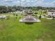 Scenic park view with a covered stage, lush green grass, and recreational spaces for community events at 13610 S Village Dr # 4212, Tampa, FL 33618