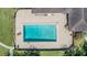 Aerial view of a fenced community pool surrounded by a patio and landscaping at 13610 S Village Dr # 4212, Tampa, FL 33618