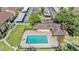 Aerial view of a well-maintained community pool with lounge seating surrounded by lush green lawns at 13610 S Village Dr # 4212, Tampa, FL 33618