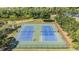 Aerial view of well maintained community tennis courts with pond and walking path views at 13610 S Village Dr # 4212, Tampa, FL 33618
