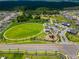 An aerial view of a meticulously landscaped community park with green spaces, walking paths, and recreational facilities at 13622 Tonya Anne Dr, Riverview, FL 33579