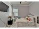 This bedroom features clean lines, a window, a full-length mirror, and modern fixtures and decor throughout at 13622 Tonya Anne Dr, Riverview, FL 33579