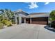 Gray two-story home featuring a three-car garage, well-kept lawn and attractive desert-style landscaping at 13622 Tonya Anne Dr, Riverview, FL 33579