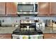 Close-up of kitchen appliances including range and microwave at 13622 Tonya Anne Dr, Riverview, FL 33579