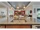 Kitchen island with granite countertop and a view of the living room at 13622 Tonya Anne Dr, Riverview, FL 33579