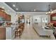 Open-concept living space with kitchen island, tile flooring, and elegant decor at 13622 Tonya Anne Dr, Riverview, FL 33579
