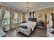 Sunlit main bedroom with a chandelier and neutral decor at 13622 Tonya Anne Dr, Riverview, FL 33579