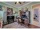 This office features a built-in desk and cabinetry, a ceiling fan, and an adjacent doorway with an attached bathroom at 13622 Tonya Anne Dr, Riverview, FL 33579