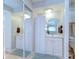 Bathroom with double vanity, mirrored closet doors, and tile flooring at 13870 Oakwood Ln # 13870, Seminole, FL 33776