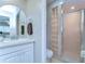 Bathroom with updated vanity, shower, and glass block wall at 13870 Oakwood Ln # 13870, Seminole, FL 33776