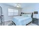 Bright bedroom with wooden flooring, a ceiling fan, and a large window offering natural light at 13870 Oakwood Ln # 13870, Seminole, FL 33776