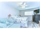Bedroom featuring a ceiling fan, beach-themed decor, and comfortable seating area at 13870 Oakwood Ln # 13870, Seminole, FL 33776