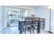 Bright dining area features wood-look floors, seating for four, and sliding glass doors to the enclosed lanai at 13870 Oakwood Ln # 13870, Seminole, FL 33776
