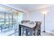 Bright dining area with wood-look floors and sliding glass doors to the enclosed lanai at 13870 Oakwood Ln # 13870, Seminole, FL 33776