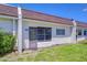 Charming exterior of a home with white siding, a front door, and a well-maintained lawn at 13870 Oakwood Ln # 13870, Seminole, FL 33776