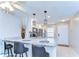 Island kitchen with granite countertops, stainless steel appliances, and modern pendant lights at 13870 Oakwood Ln # 13870, Seminole, FL 33776